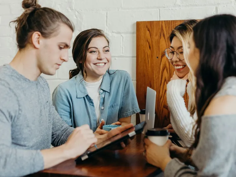Teammates sharing ideas together in a bright office